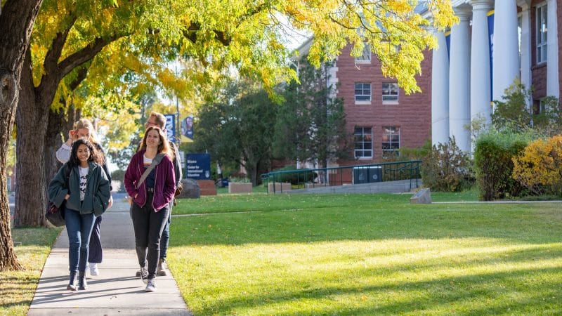 Students walking on campus in the fall.