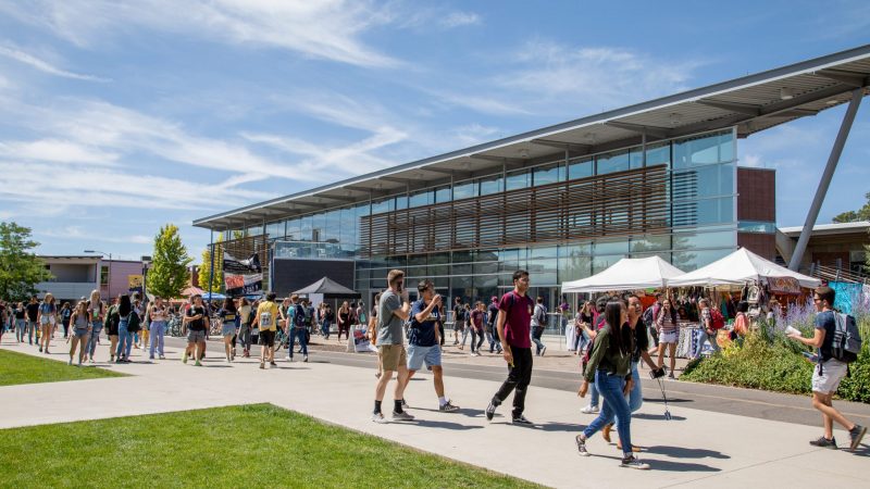 Students walk on the Flagstaff campus in the summer sunshine.