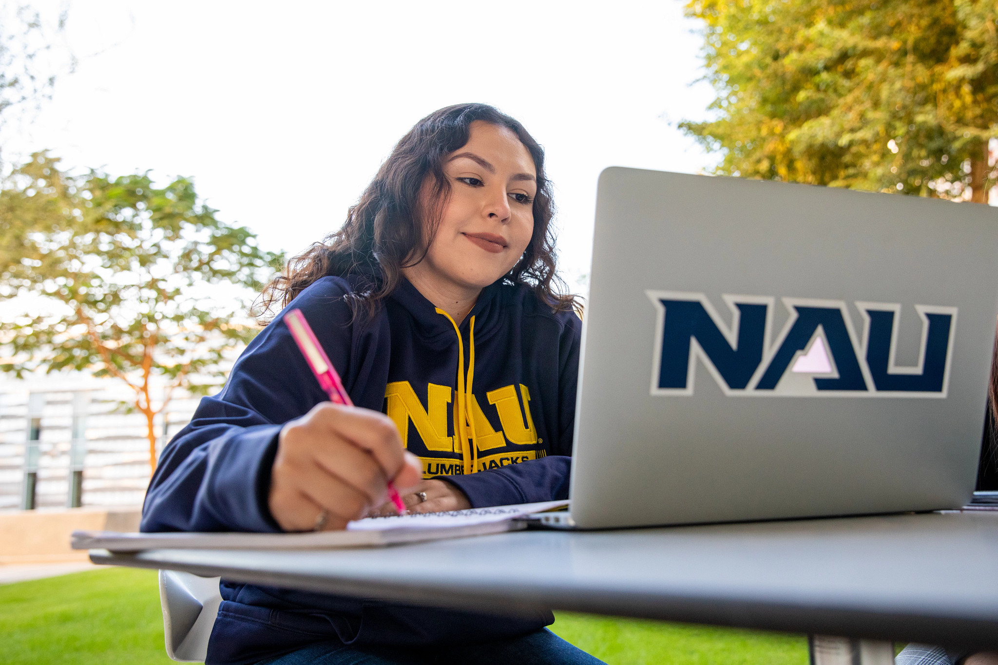 N A U–Yuma student working on laptop.