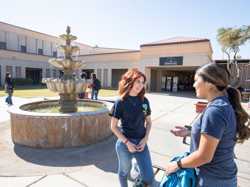 N A U–Yuma students near water fountain.